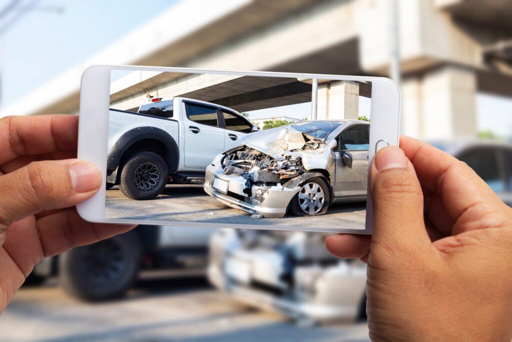 Documenting Car Accident Scene in Fort Worth for Insurance Claim and Injury Case Driver Taking Photo of Car Accident Damage on Fort Worth Highway for Insurance and Legal Documentation