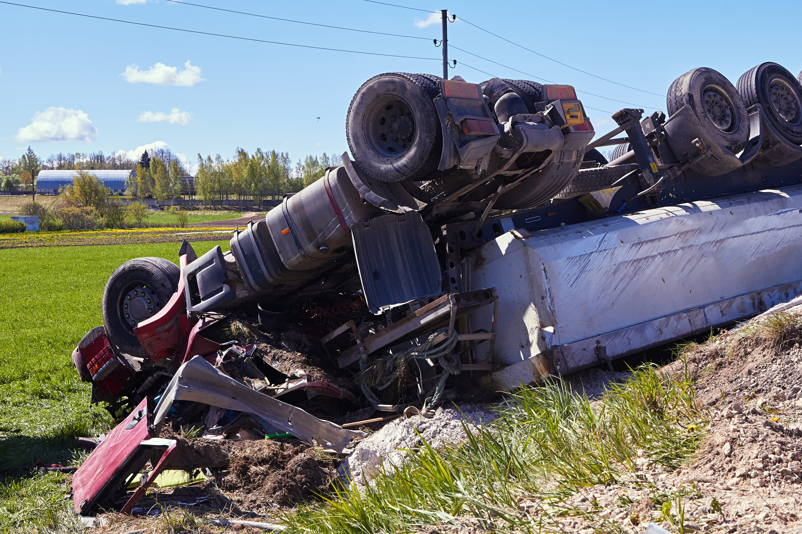 Overturned semi truck in ditch representing fatal trucking accident and wrongful death case in Weatherford